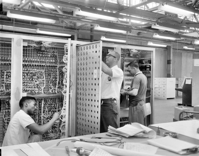 Technicians struggling with a control cabinet
