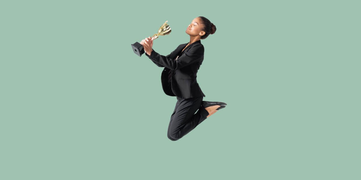 Jumping woman with trophy